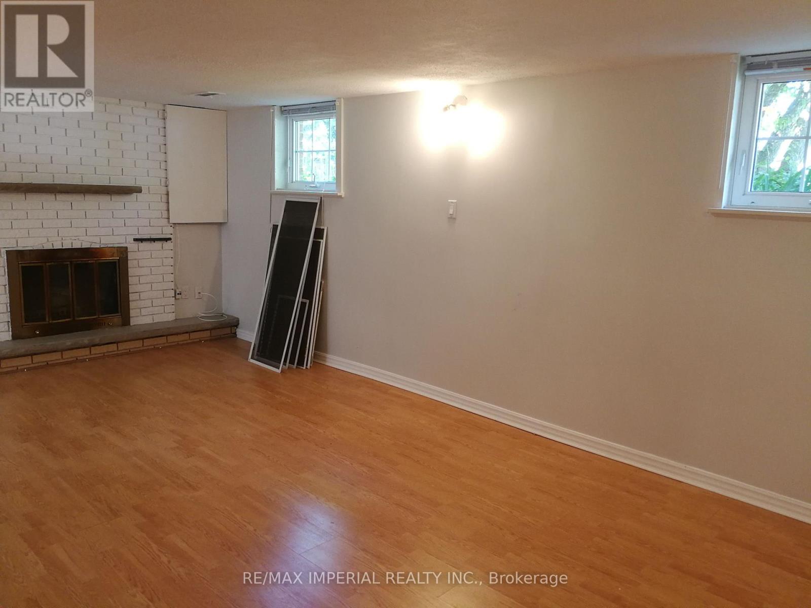 A room with a fireplace and wooden floors.