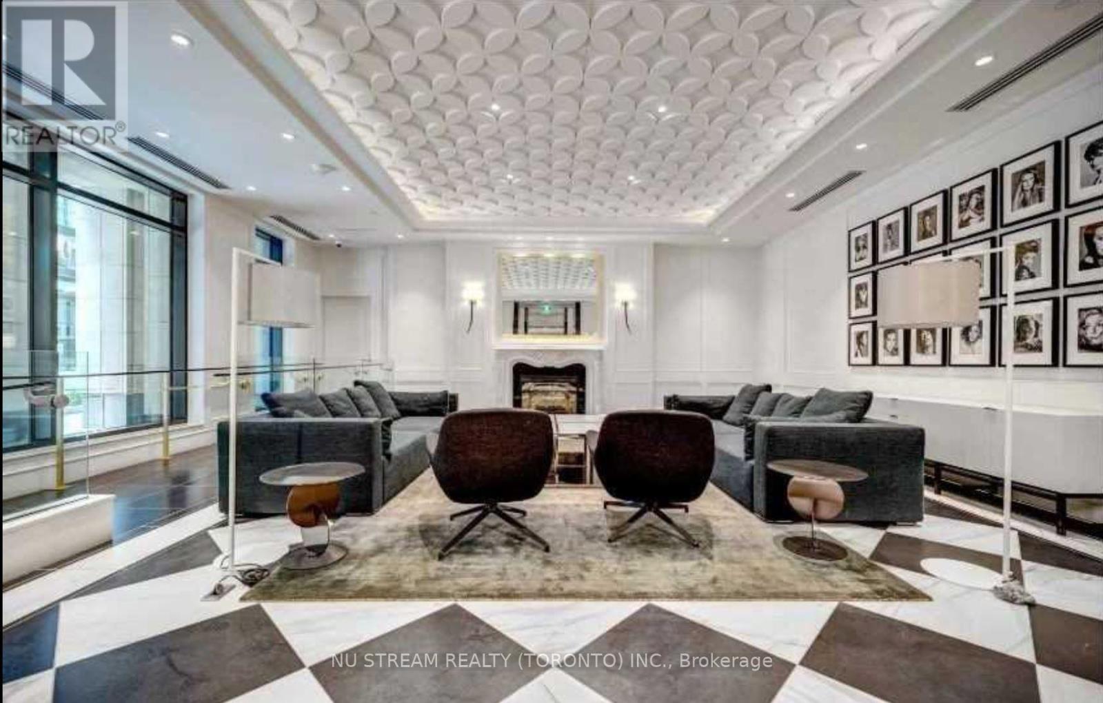 A living room with a checkered floor and a fireplace.