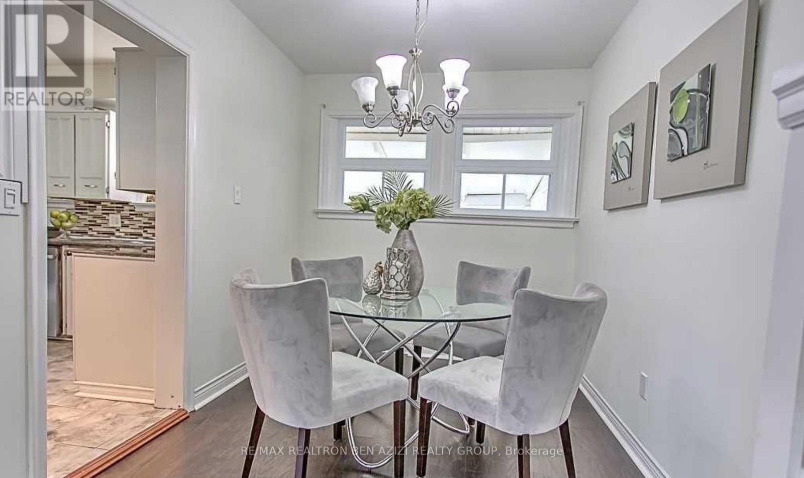 A dining room with a glass table and chairs.