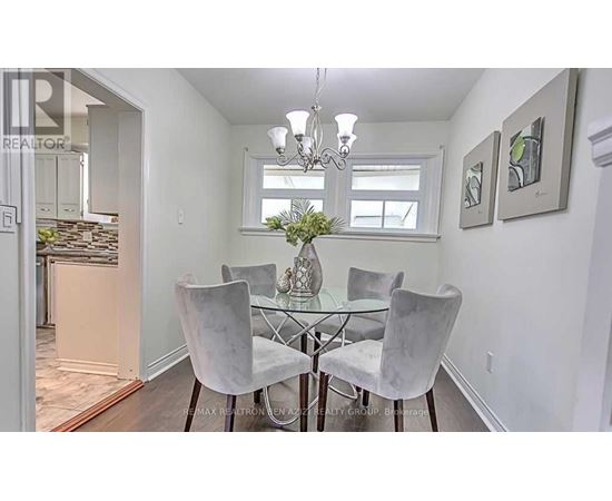 A dining room with a glass table and chairs.