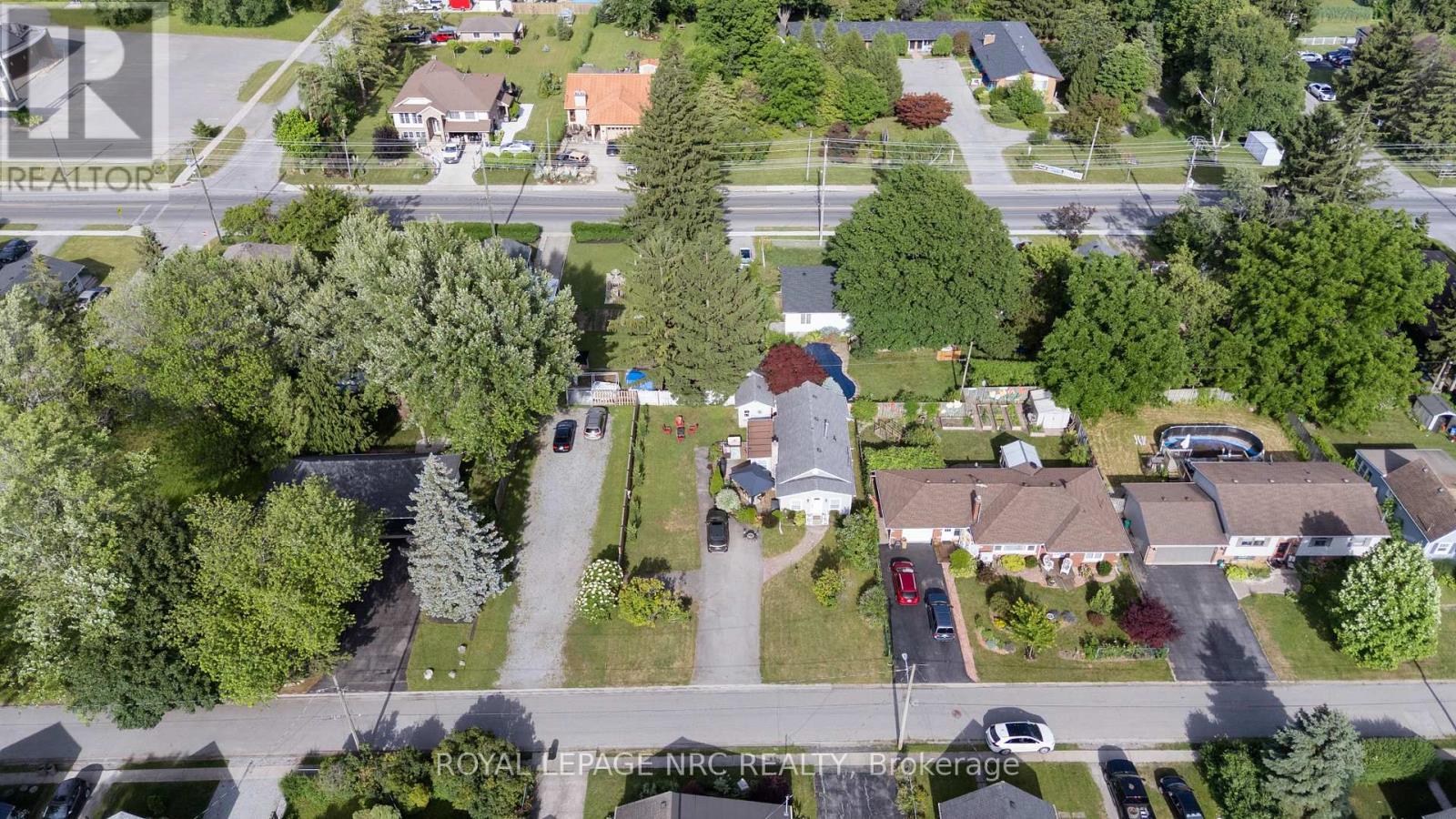 A bird's eye view of a residential area with houses and trees.