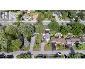 A bird's eye view of a residential area with houses and trees.