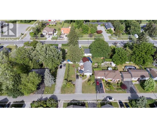 A bird's eye view of a residential area with houses and trees.