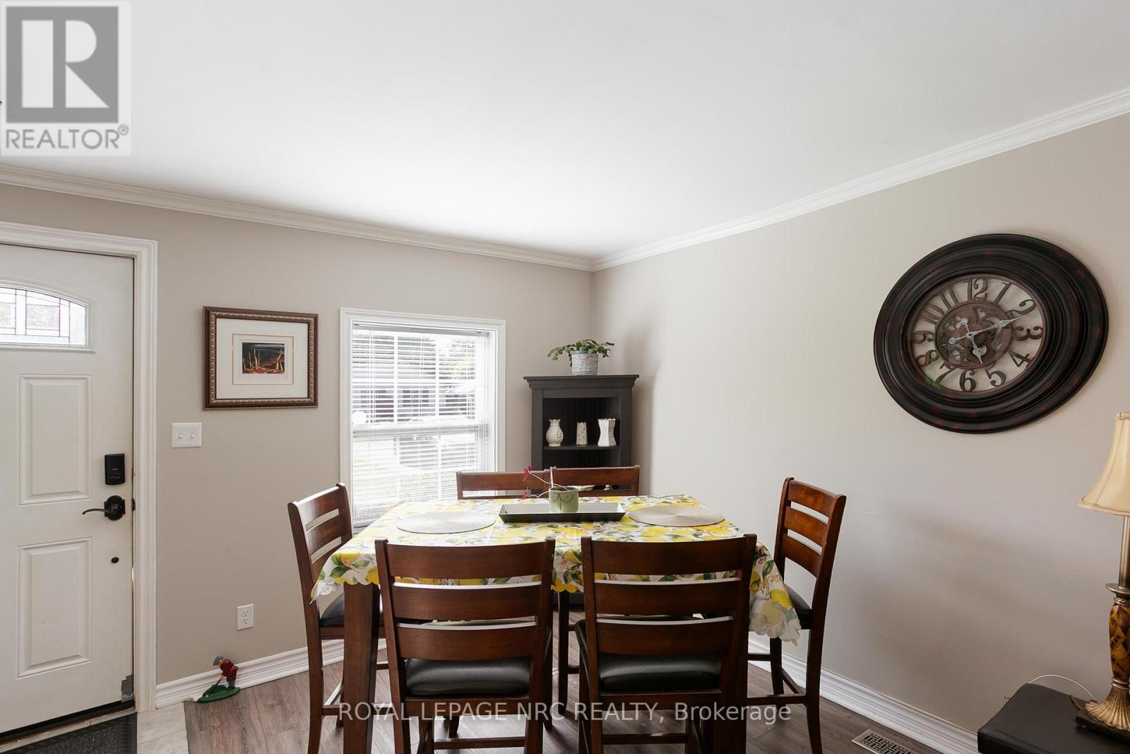 A dining room with a table set for four.