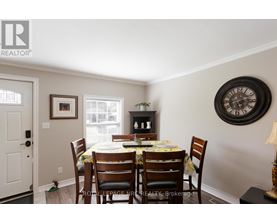 A dining room with a table set for four.
