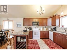 A kitchen with wooden cabinets and a granite countertop.