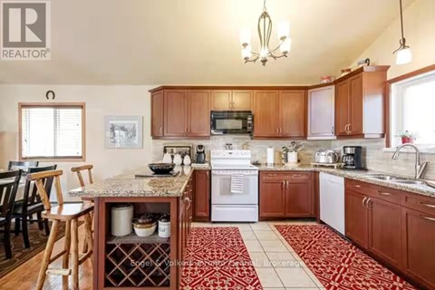 A kitchen with wooden cabinets and a granite countertop.