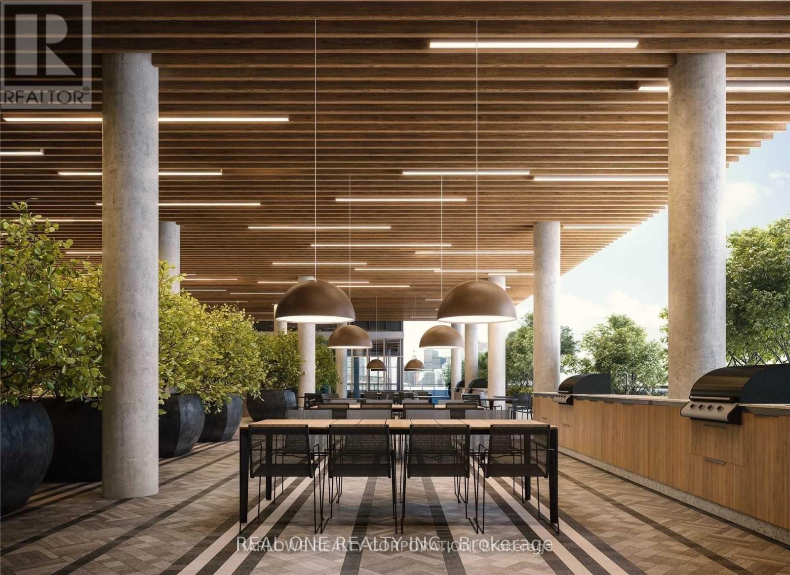 A modern dining area with wooden floors and a long table surrounded by chairs.