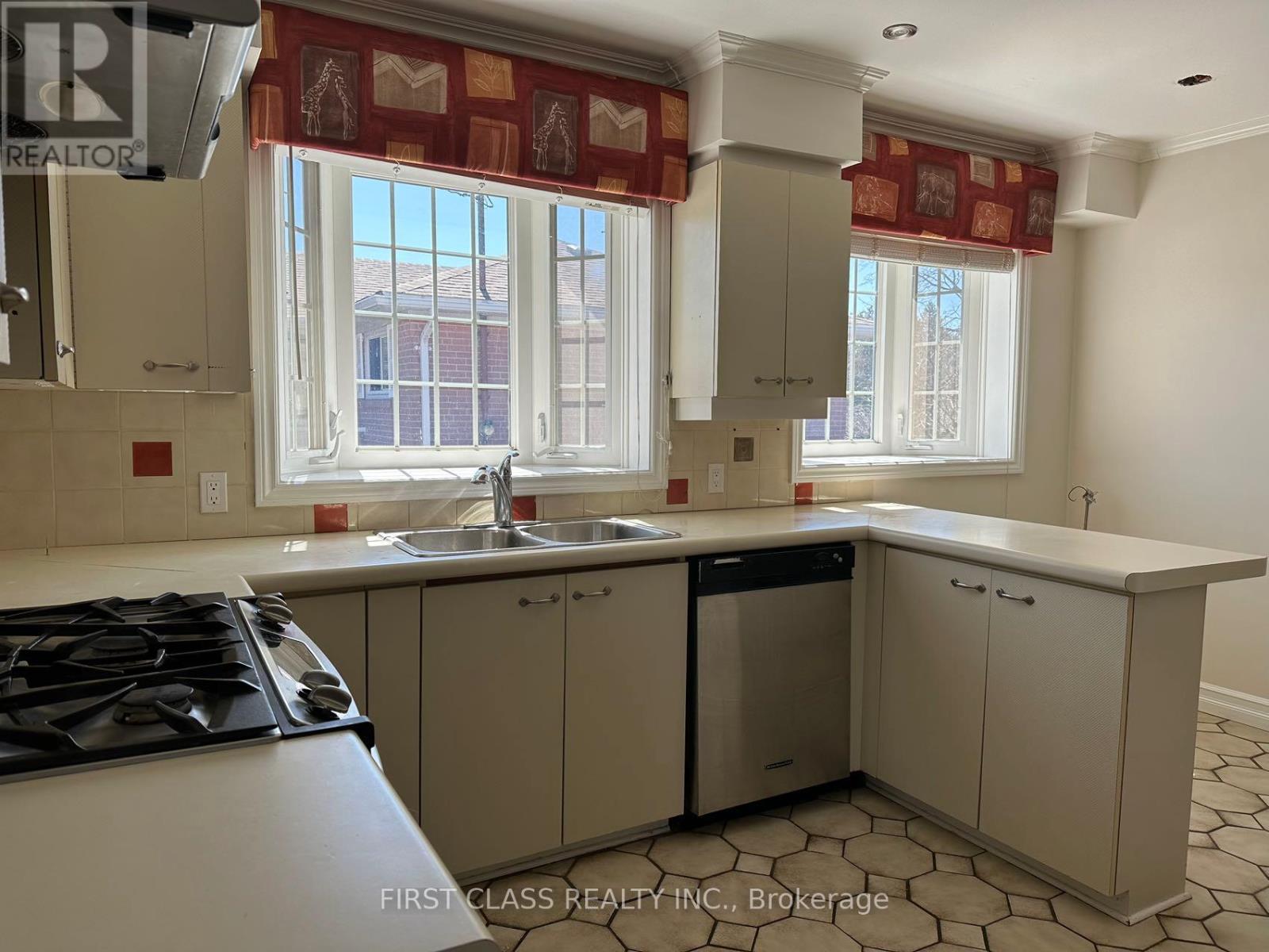 A kitchen with a stove top oven and a dishwasher.