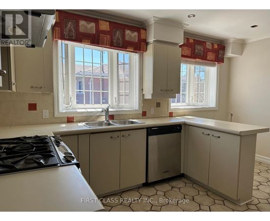 A kitchen with a stove top oven and a dishwasher.