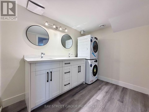 A laundry room with a washer and dryer built into the cabinetry.