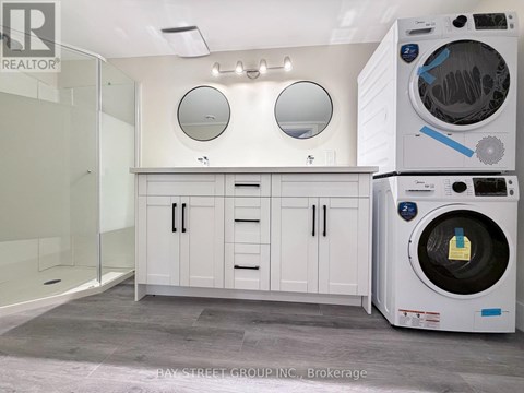 A laundry room with a washer and dryer stacked on top of each other.