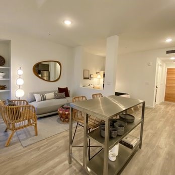 A modern dining room with a wooden chair and a metal table.