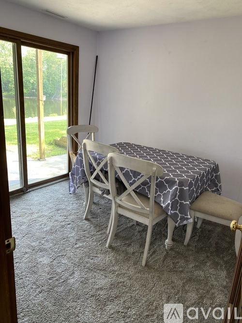 A dining room with a table and chairs.