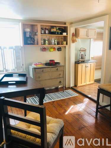 A kitchen with wooden floors and furniture.
