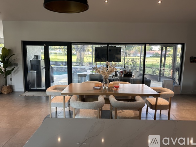 A modern dining room with a large table and chairs.