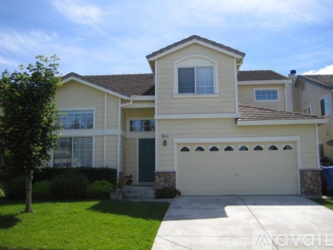 A two-story house with a garage and a driveway.