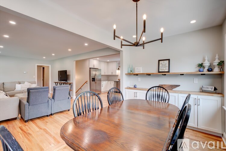 A dining room with a wooden table and chairs.