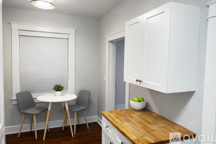 A small dining area with a table and chairs.