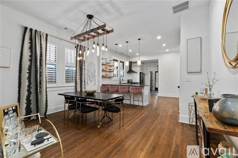 A dining room with a wooden table and chairs.