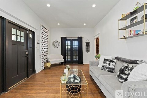 A living room with a white couch and a coffee table in the center.