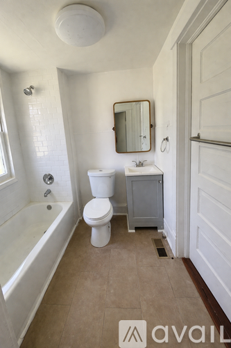 A bathroom with a toilet, sink, and bathtub.
