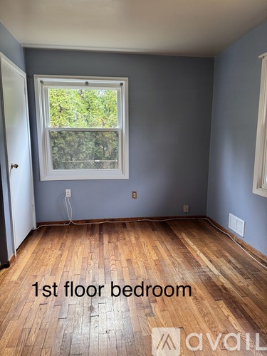 A room with wooden floors and a window.