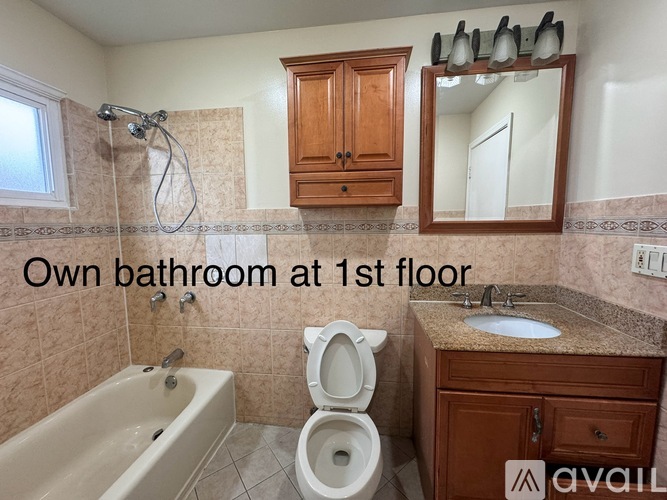A bathroom with a toilet, sink, and bathtub.