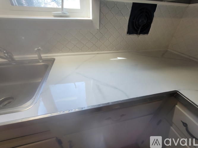 A kitchen counter with a sink and a window.