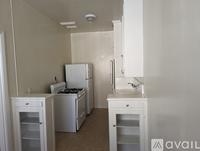 A kitchen with white appliances and cabinets.