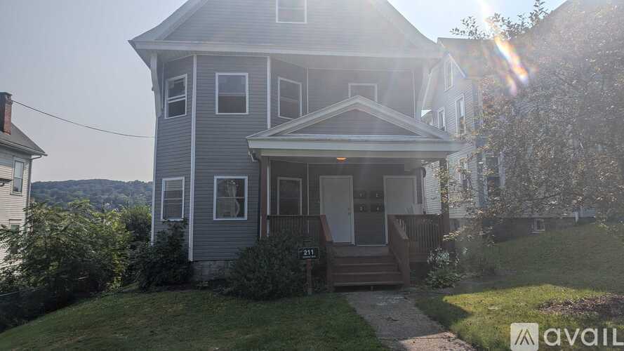 A house with a porch and a sign that says "available".