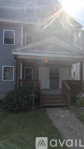 A house with the number 211 on the front lawn.