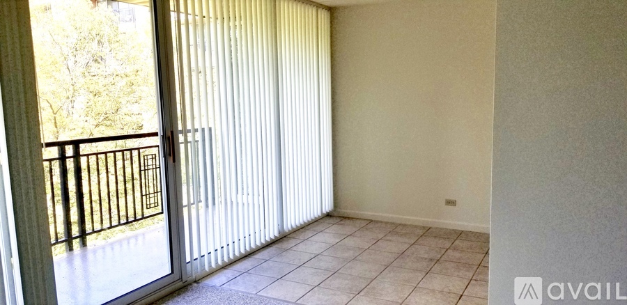 A room with a sliding door leading to a balcony.