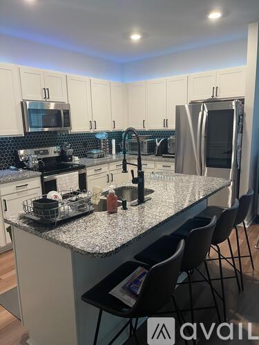 A kitchen with granite countertops and stainless steel appliances.