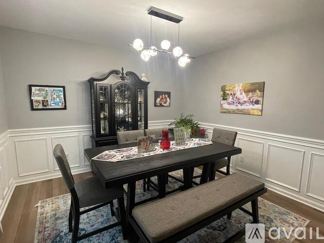 A dining room with a wooden table and chairs.