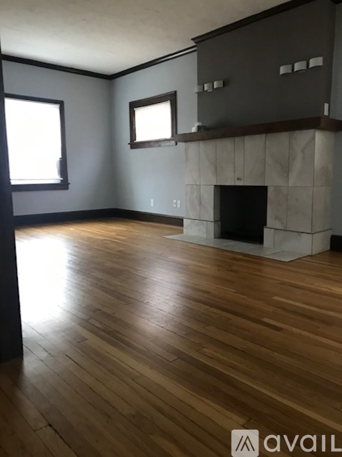 A room with wooden floors and a fireplace.