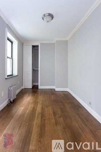 A room with wooden floors and white walls.