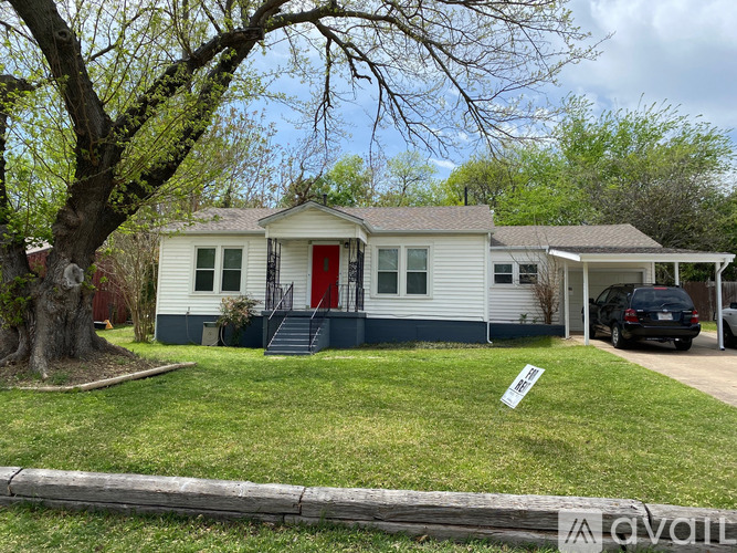 A house with a red door is for sale.