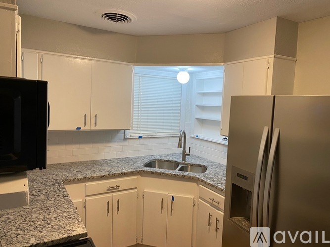 A kitchen with granite countertops and stainless steel appliances.