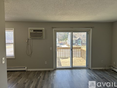 A room with a sliding glass door leading to a deck.