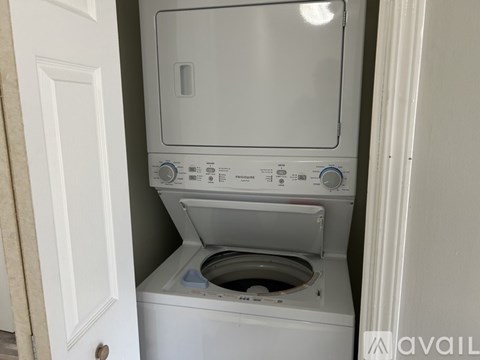 A white washing machine and dryer in a small laundry room.
