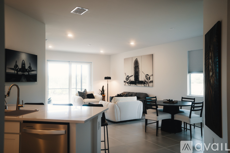 A modern kitchen with a dining area and a large window.