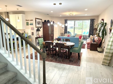 A living room with a dining table and chairs.