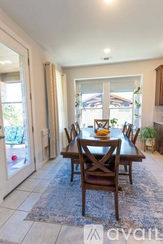A dining room with a table set for two.