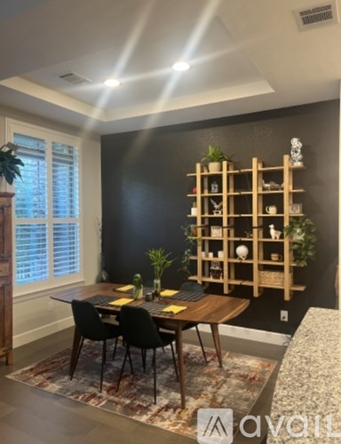 A dining room with a wooden table and chairs.