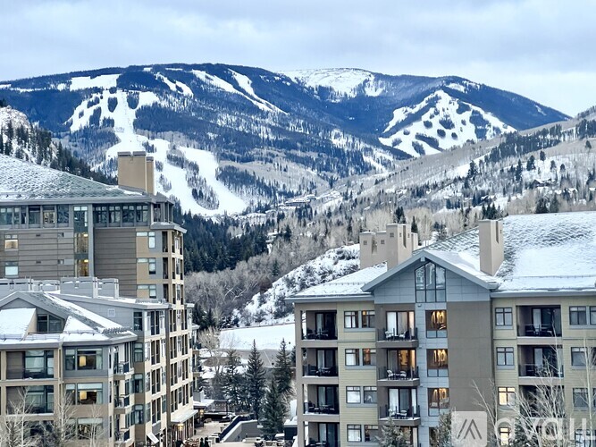 Apartment buildings in a snowy mountain town.