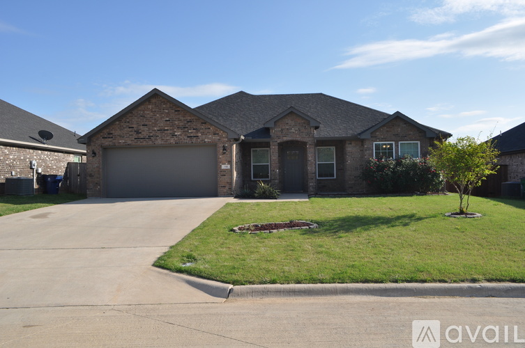 A house with a garage and a driveway in front.