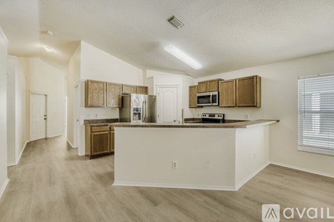 A kitchen with wooden cabinets and a white countertop.