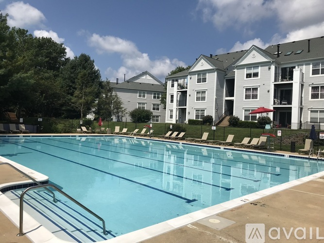 A large swimming pool in front of a hotel.