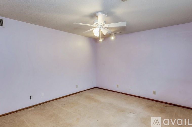 A room with a ceiling fan and lights.